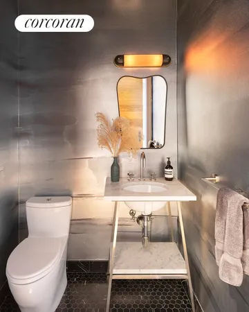 a kitchen with stainless steel appliances kitchen island granite countertop a refrigerator and a sink