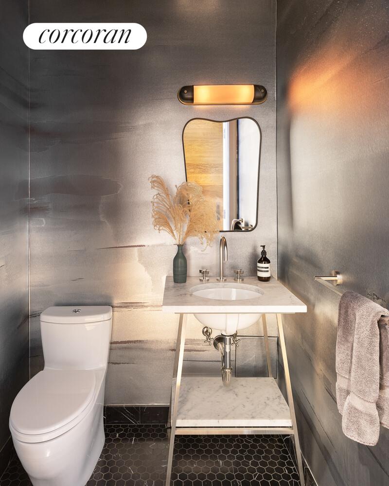 80 Leonard Street, Unit 5H Manhattan, NY 10013 - Photo 8 of 15 a bathroom with a toilet a sink and mirror