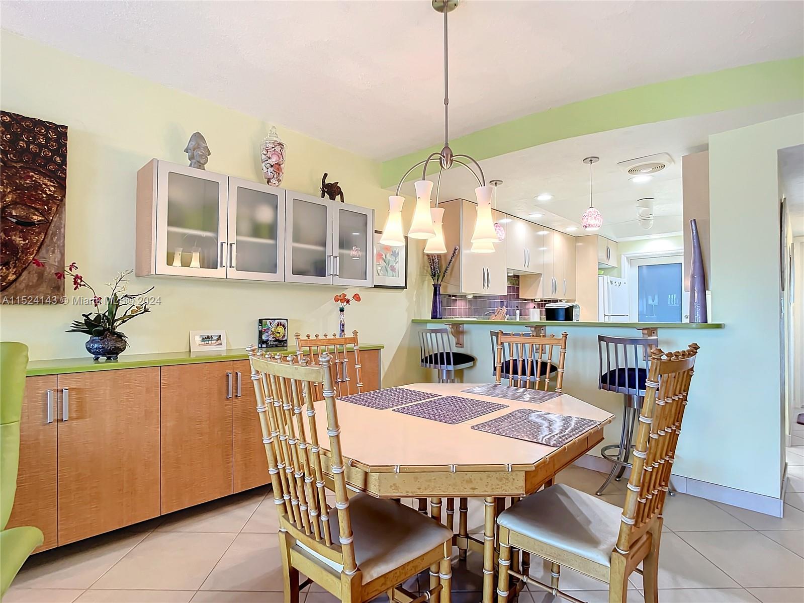 320 South Surf Road, Unit 506 Hollywood, FL 33019 - Photo 14 of 36 a view of a dining room and chandelier