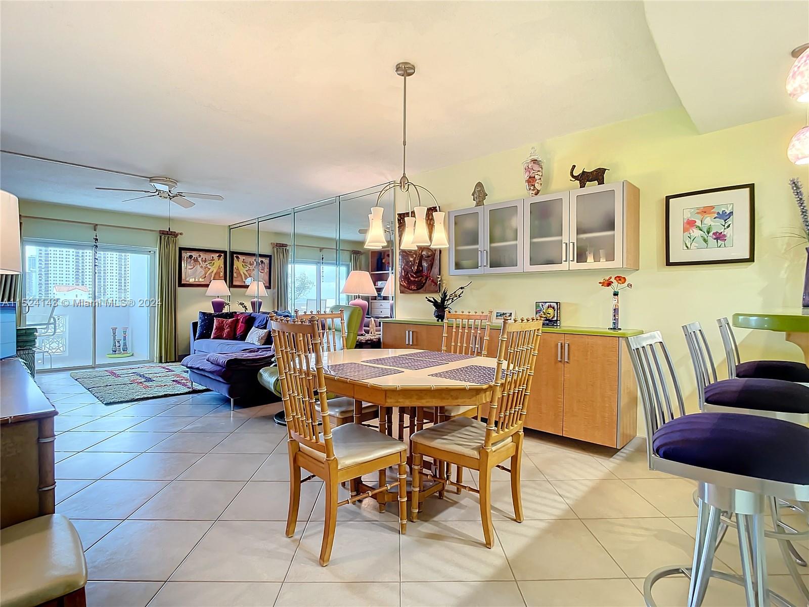320 South Surf Road, Unit 506 Hollywood, FL 33019 - Photo 15 of 36 a living room with furniture and a chandelier