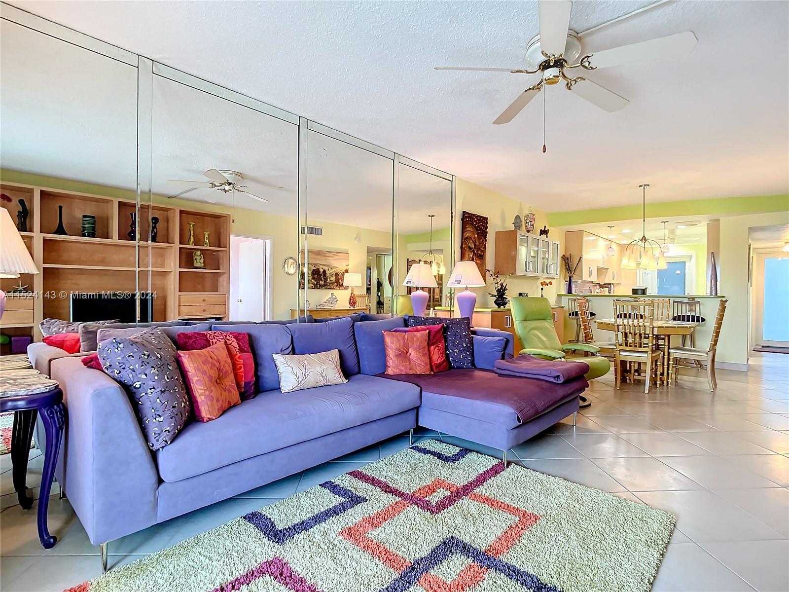 320 South Surf Road, Unit 506 Hollywood, FL 33019 - Photo 18 of 36 a living room with furniture ceiling fan and a rug