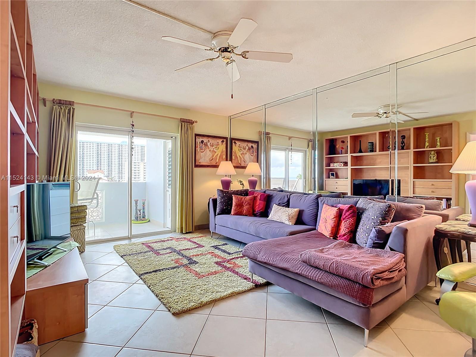 320 South Surf Road, Unit 506 Hollywood, FL 33019 - Photo 19 of 36 a living room with furniture and a chandelier