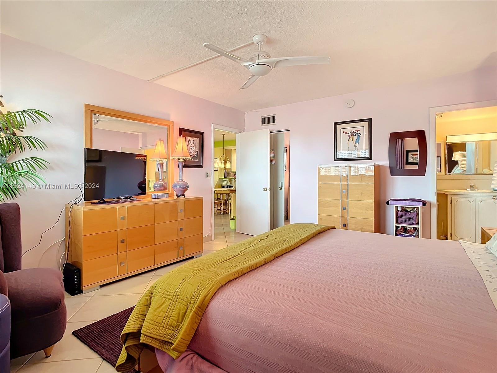 320 South Surf Road, Unit 506 Hollywood, FL 33019 - Photo 27 of 36 a bedroom with a bed and wooden floor