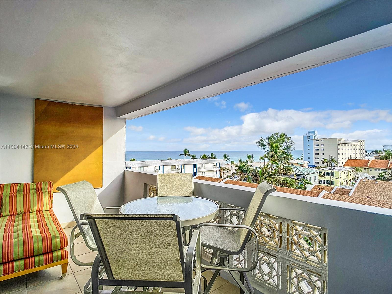 320 South Surf Road, Unit 506 Hollywood, FL 33019 - Photo 29 of 36 a dining room with furniture and a floor to ceiling window