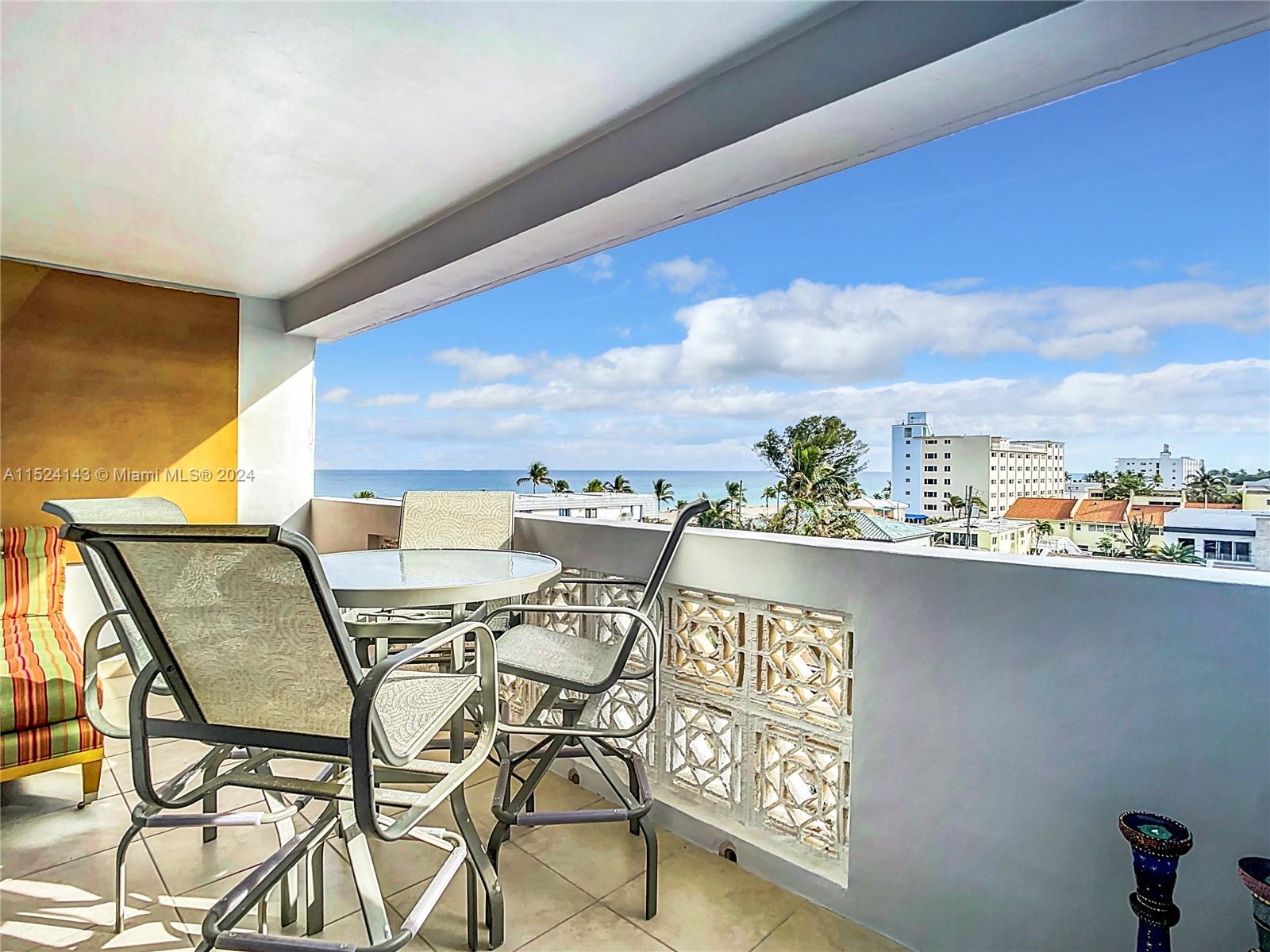 320 South Surf Road, Unit 506 Hollywood, FL 33019 - Photo 31 of 36 a balcony with table and chairs