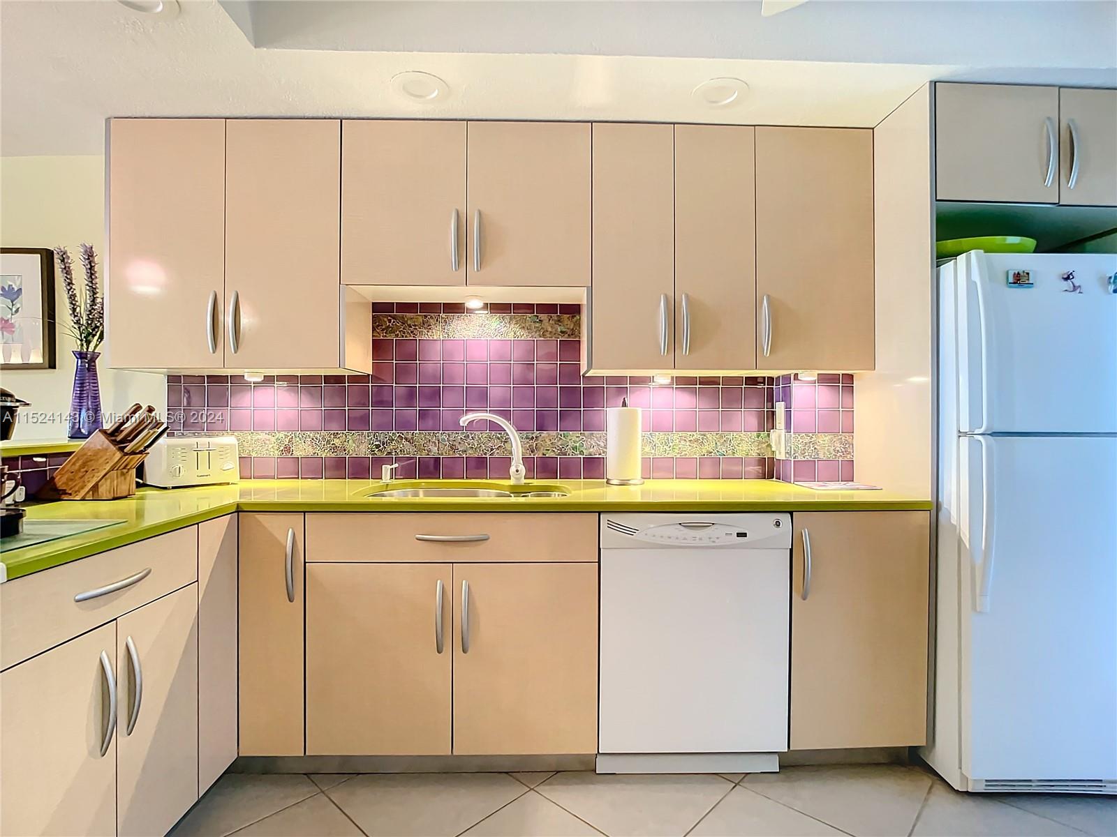 320 South Surf Road, Unit 506 Hollywood, FL 33019 - Photo 5 of 36 a kitchen with cabinets and a refrigerator