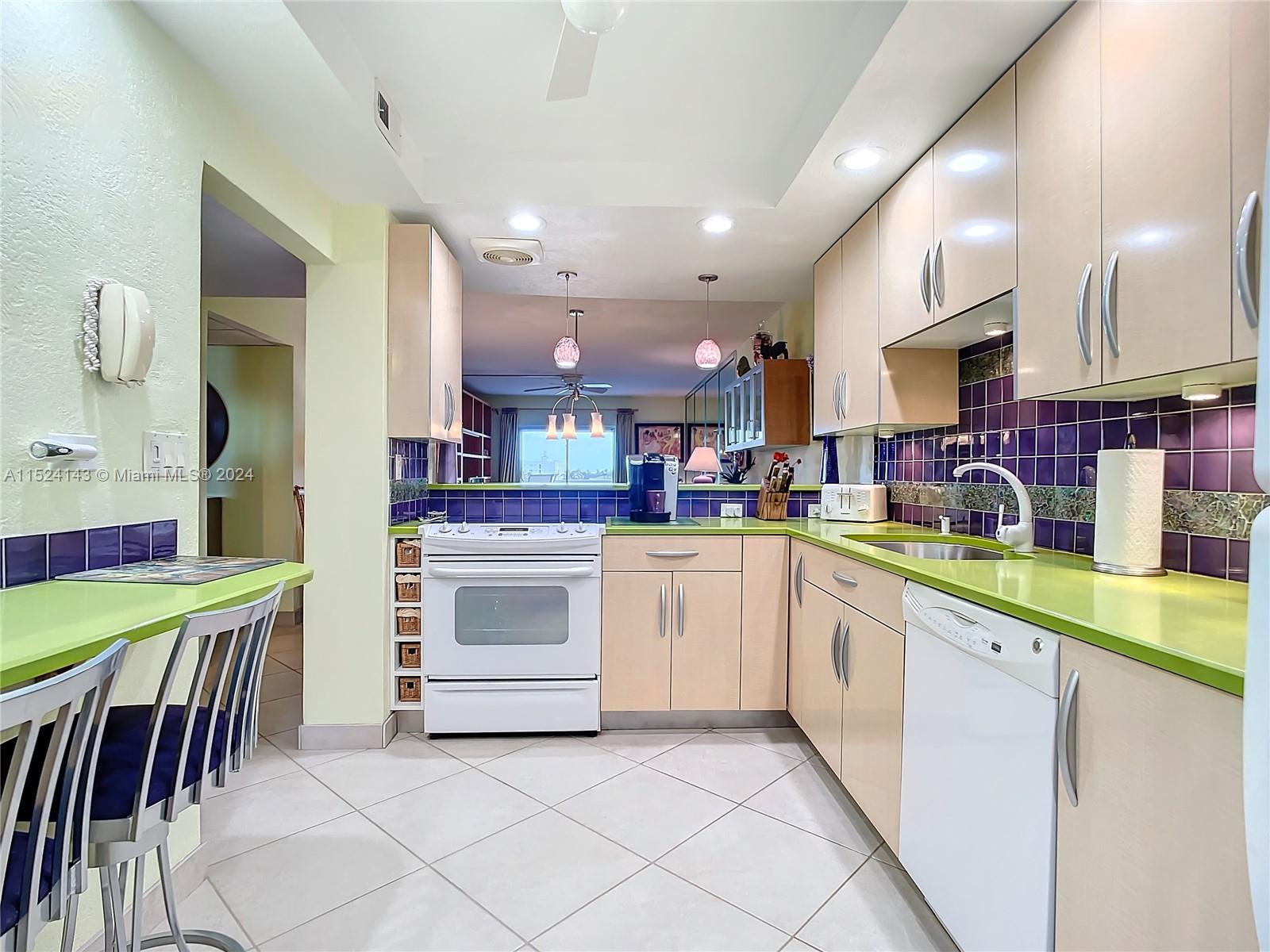 320 South Surf Road, Unit 506 Hollywood, FL 33019 - Photo 6 of 36 a kitchen with stainless steel appliances granite countertop a sink and cabinets