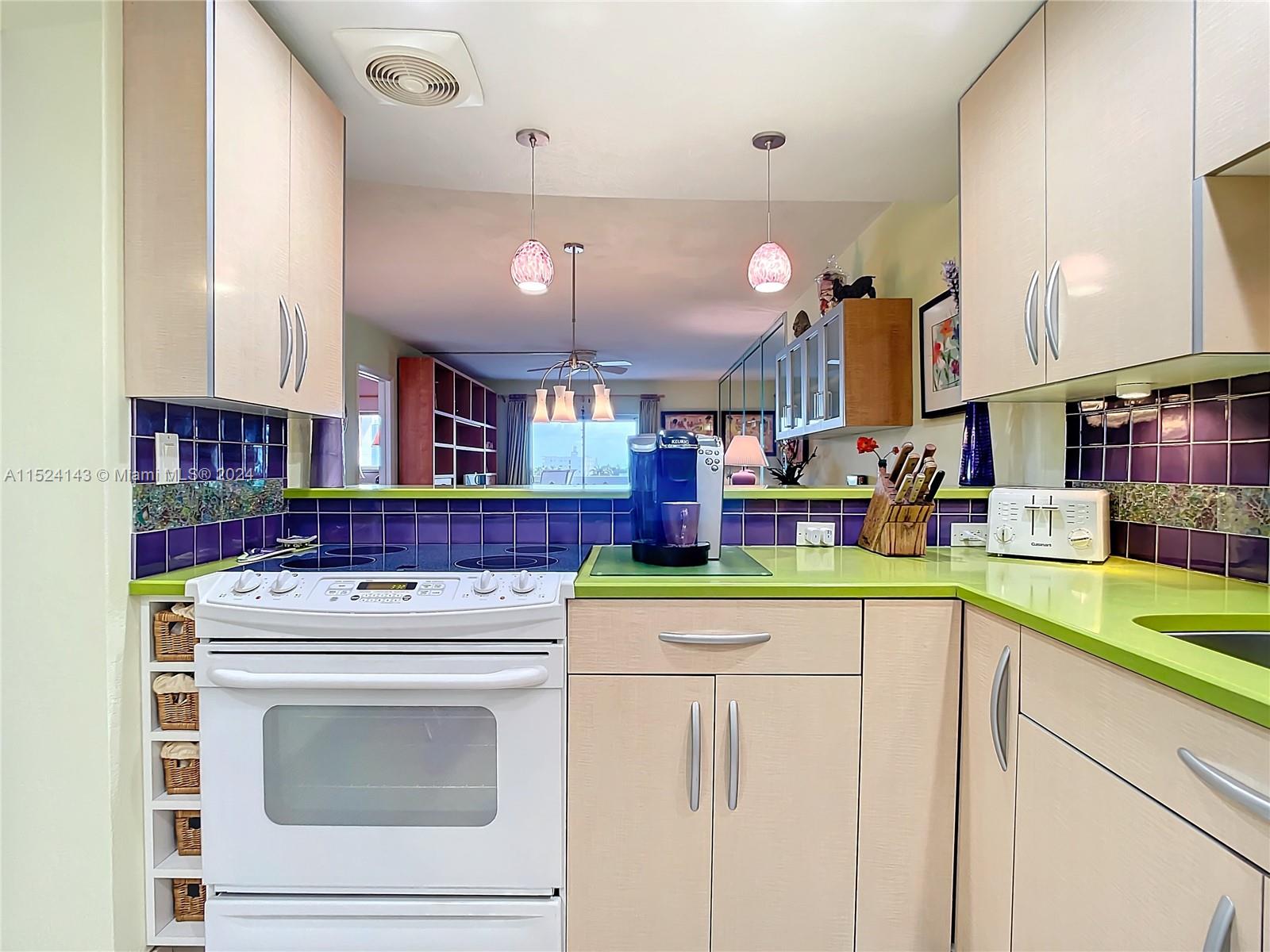 320 South Surf Road, Unit 506 Hollywood, FL 33019 - Photo 7 of 36 a kitchen with a stove and cabinets