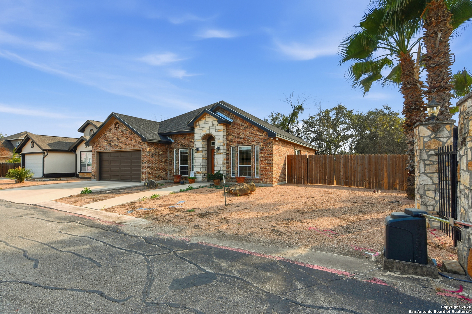101 Sutton Place Uvalde, TX 78801 - Photo 1 of 36 a front view of a house with a yard and garage