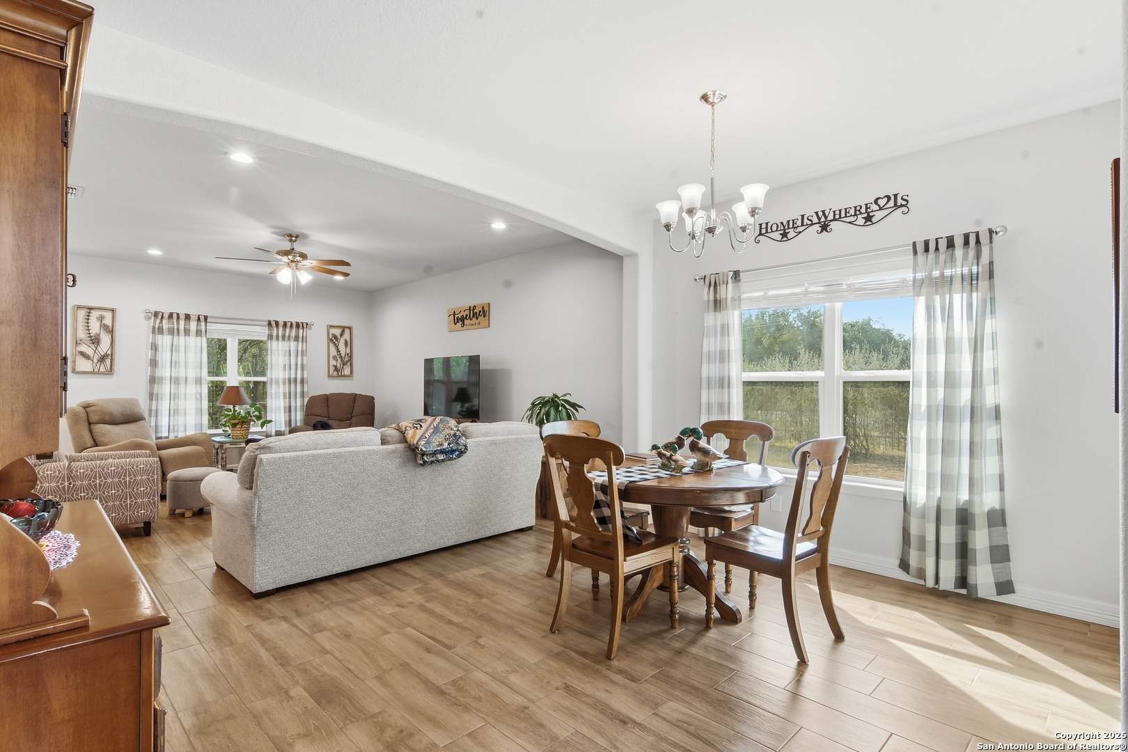101 Sutton Place Uvalde, TX 78801 - Photo 11 of 36 a view of a dining room with furniture window and wooden floor