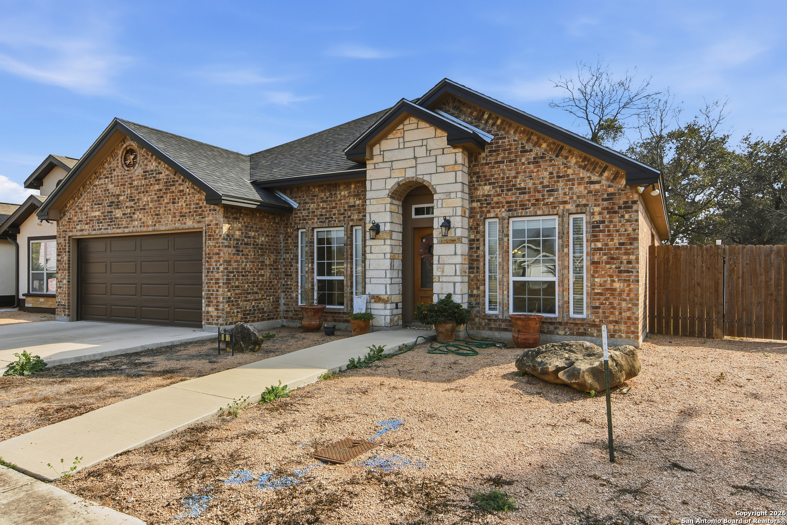 101 Sutton Place Uvalde, TX 78801 - Photo 12 of 36 a front view of a house with a yard and garage