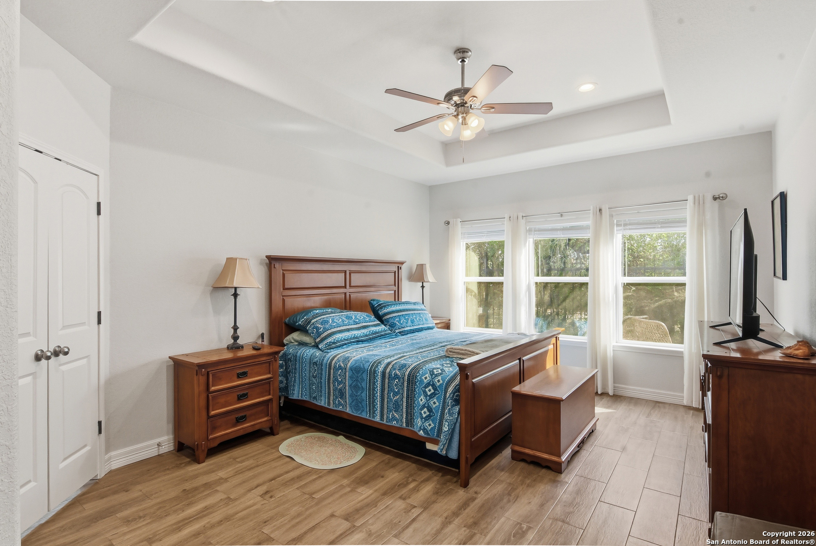 101 Sutton Place Uvalde, TX 78801 - Photo 22 of 36 a bedroom with a bed and a large window with wooden floor