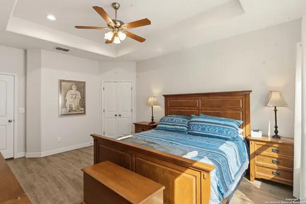 a bedroom with a bed and a ceiling fan