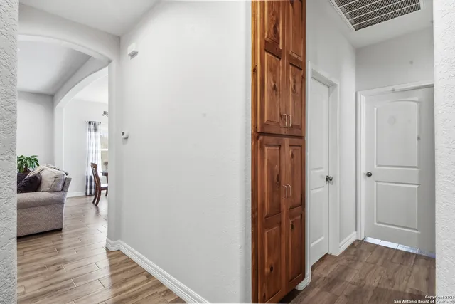 a view of a hallway view with wooden floor and furniture