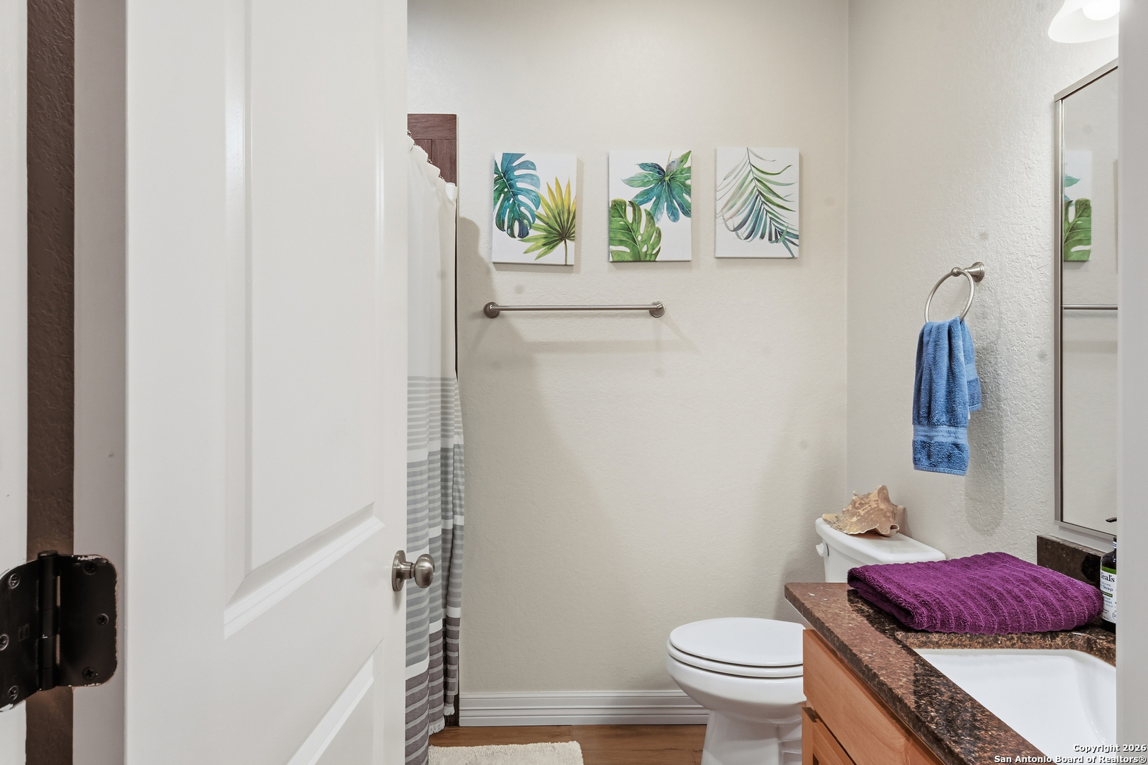 101 Sutton Place Uvalde, TX 78801 - Photo 26 of 36 a bathroom with a toilet and a shower curtain