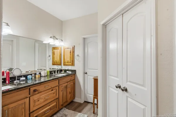 a spacious bathroom with a double vanity sink a mirror and a shower