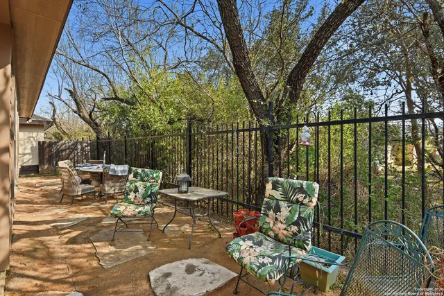 a view of a patio with couches table and chairs and potted plants