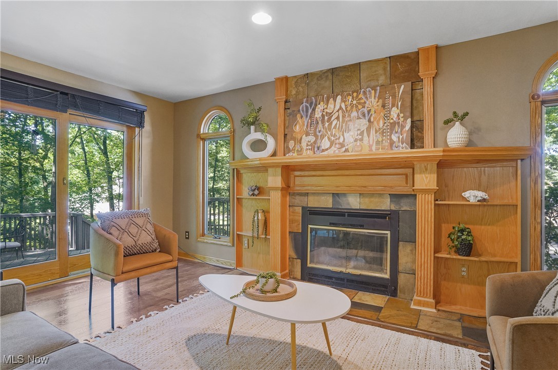 370 Wilcox Road Youngstown, OH 44515 - Photo 14 of 49 Living room featuring healthy amount of natural light, a tile fireplace, and wood finished floors