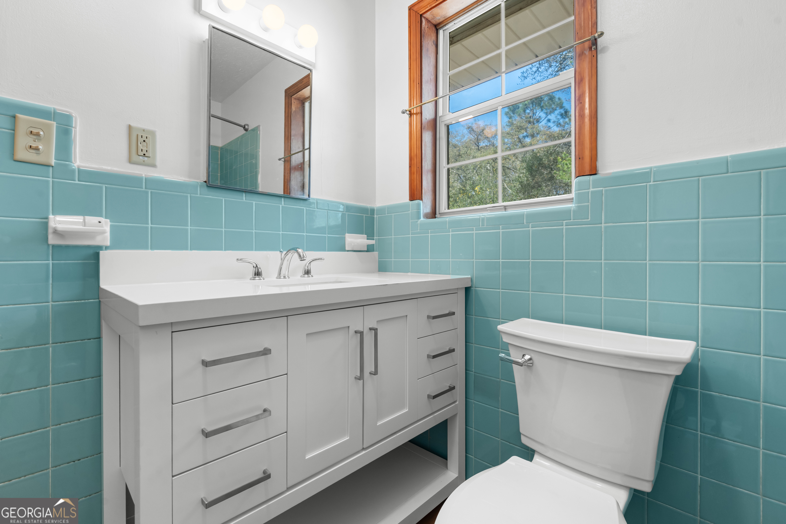 181 Heidt Road Guyton, GA 31312 - Photo 12 of 24 a bathroom with a sink mirror vanity and toilet