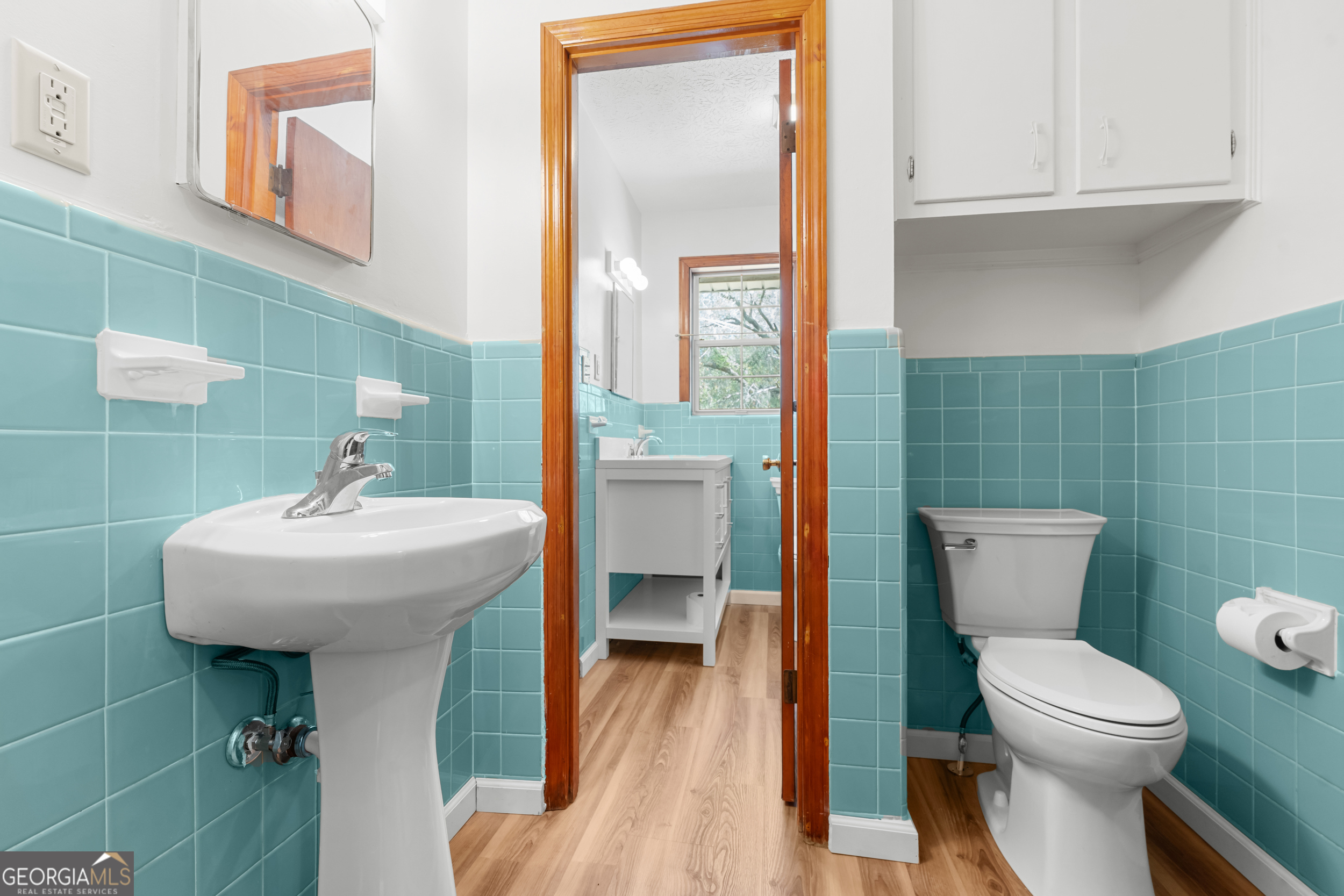 181 Heidt Road Guyton, GA 31312 - Photo 16 of 24 a bathroom with a toilet a sink and mirror