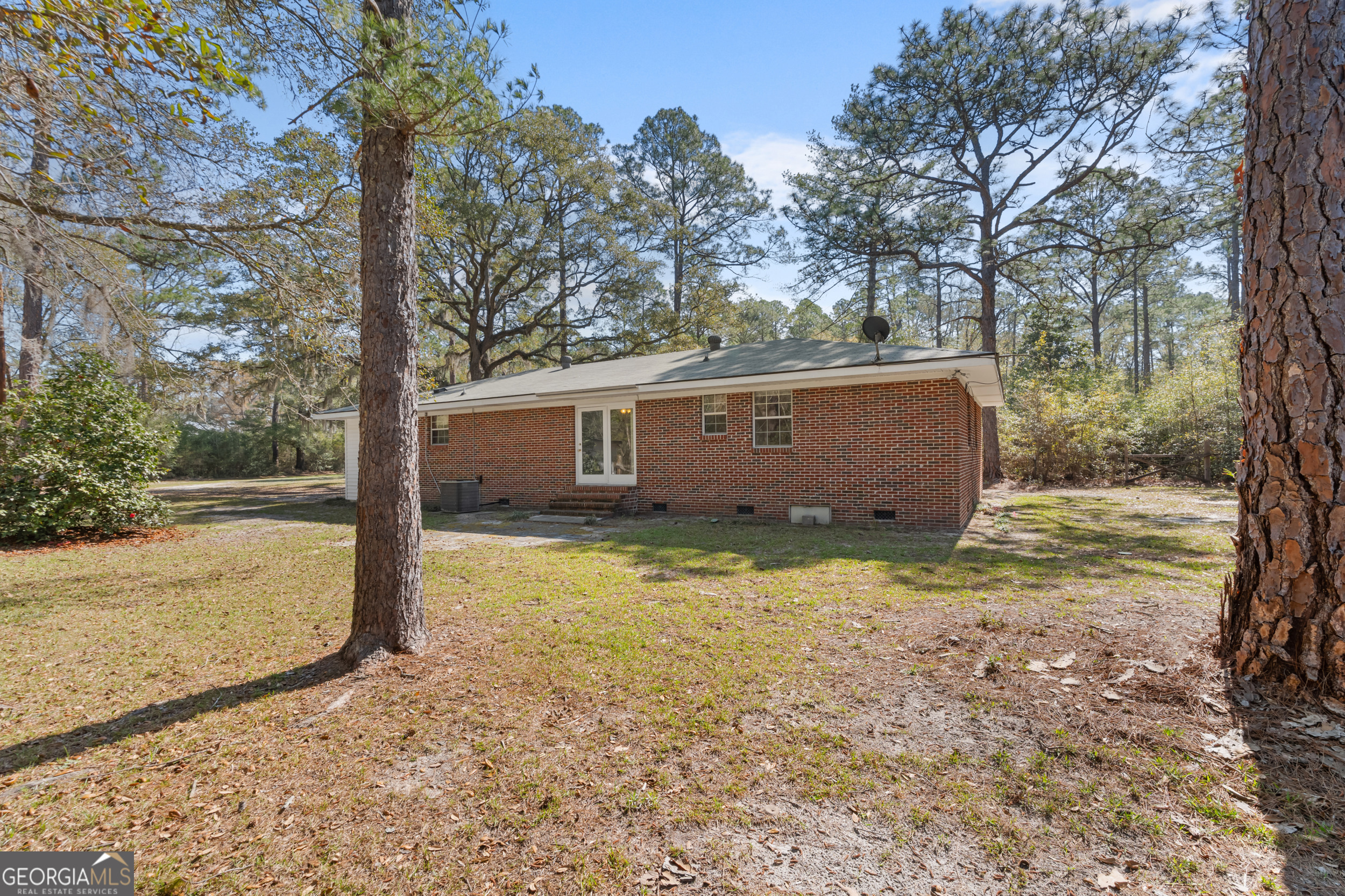 181 Heidt Road Guyton, GA 31312 - Photo 20 of 24 a view of a house with backyard and trees