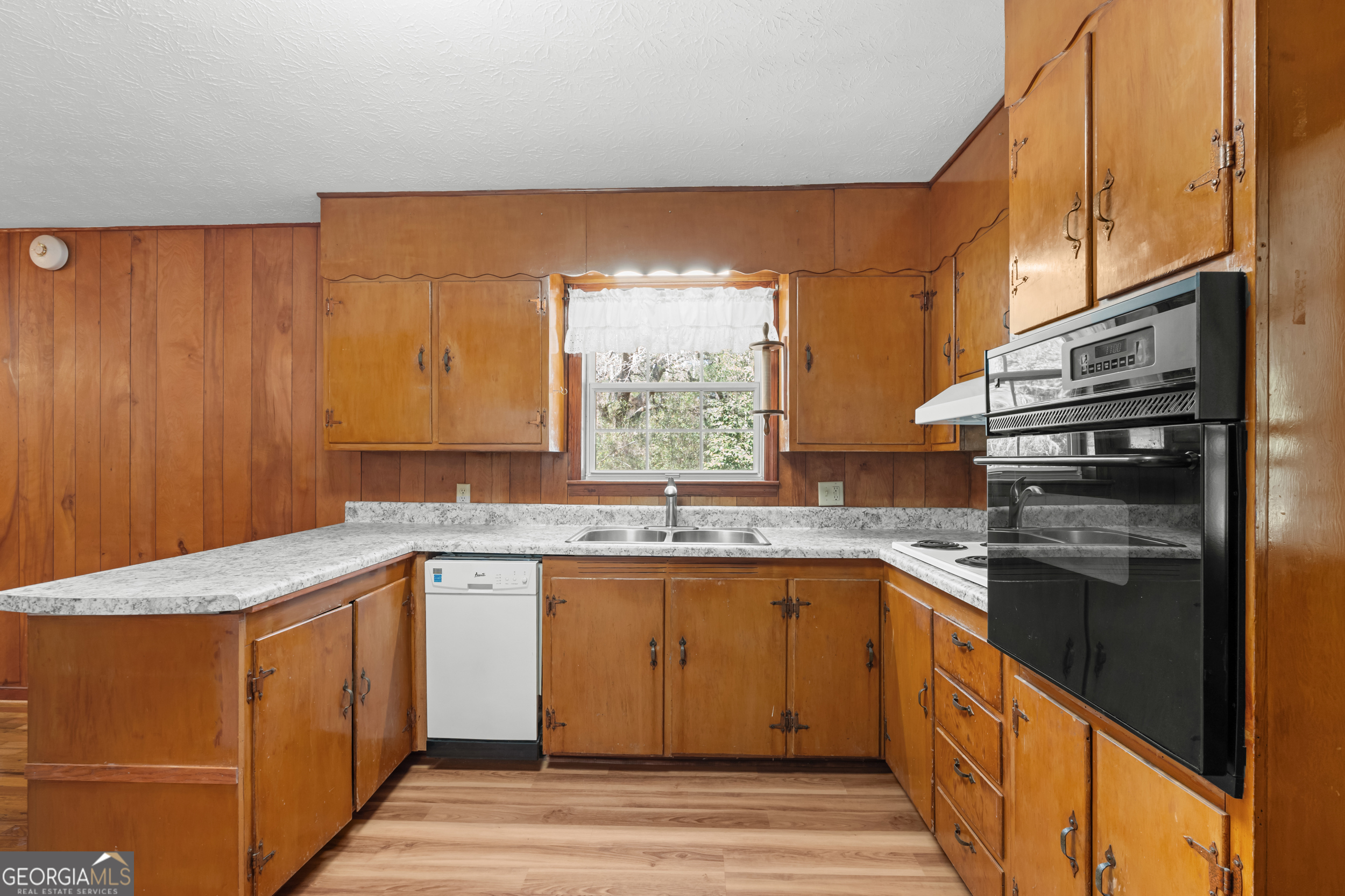 181 Heidt Road Guyton, GA 31312 - Photo 6 of 24 a kitchen with a sink stove and cabinets
