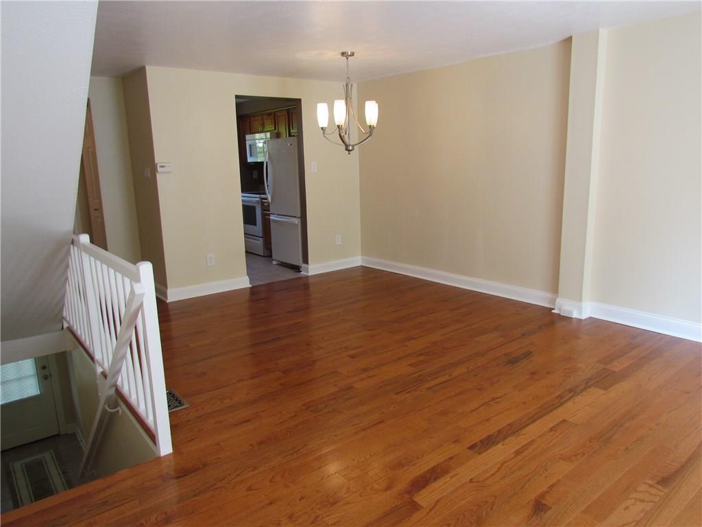 5491 Library Road, Unit 21 Bethel Park, PA 15102 - Photo 5 of 25 TOP OF THE ENTRY STAIRS - OPEN CONCEPT LIVING AND DINING ROOM-HARDWOOD FLOORING AND FRESHLY PAINTED!