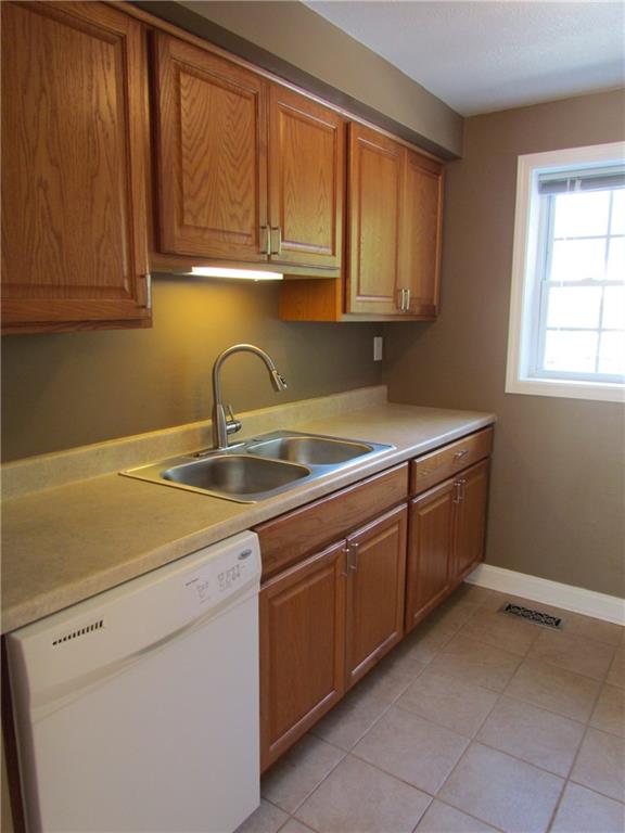 5491 Library Road, Unit 21 Bethel Park, PA 15102 - Photo 8 of 25 THE KITCHEN - CLEAN AND EFFICIENT! CERAMIC TILE HERE TOO - STAINLESS STEEL DOUBLE BOWL SINK AND BRUSHED NICKEL FIXTURES...
