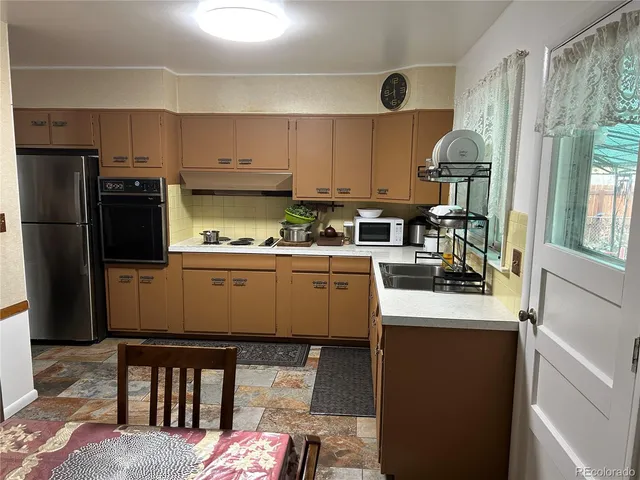 a kitchen with a sink a stove and refrigerator