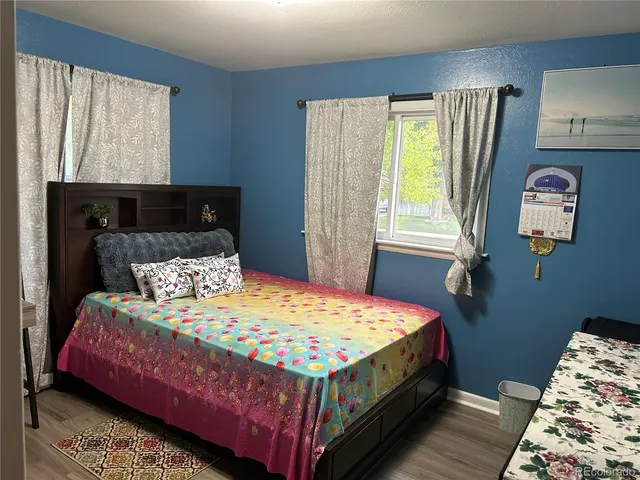 a bedroom with a bed lamp and a window