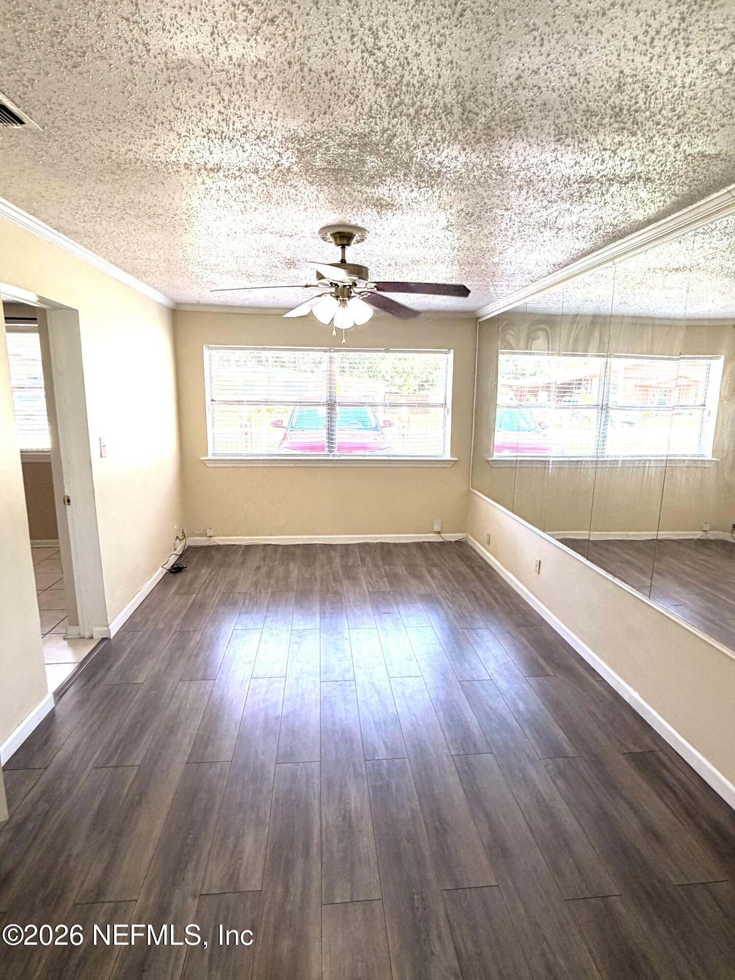 4127 Springwood Road Jacksonville, FL 32207 - Photo 18 of 63 an empty room with wooden floor and windows