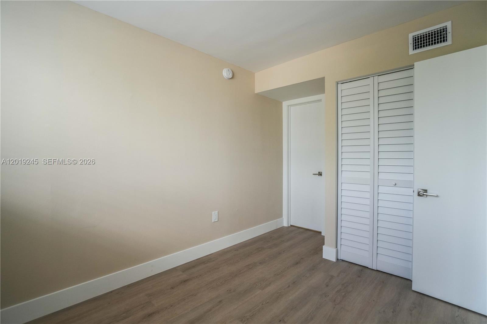 6960 Rue Vendome, Unit 201 Miami Beach, FL 33141 - Photo 16 of 27 an empty room with wooden floor
