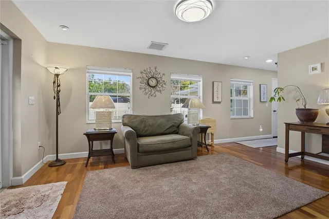 a kitchen with stainless steel appliances a table and chairs in it