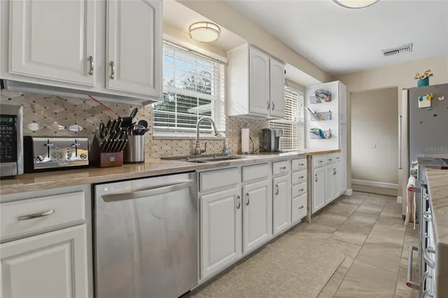 a bedroom with furniture and a flat screen tv