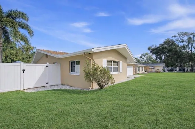 a front view of house with yard and outdoor seating