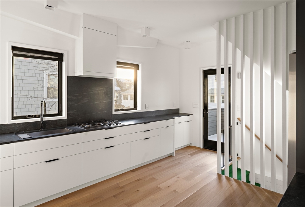 78 Gilbert Road Belmont, MA 02478 - Photo 7 of 20 a kitchen with granite countertop white cabinets and white appliances