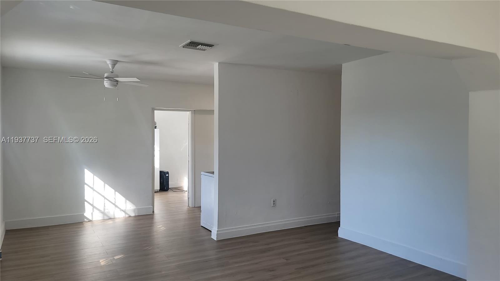 2951 Northwest 49th Street Miami, FL 33142 - Photo 13 of 19 a view of an empty room with wooden floor