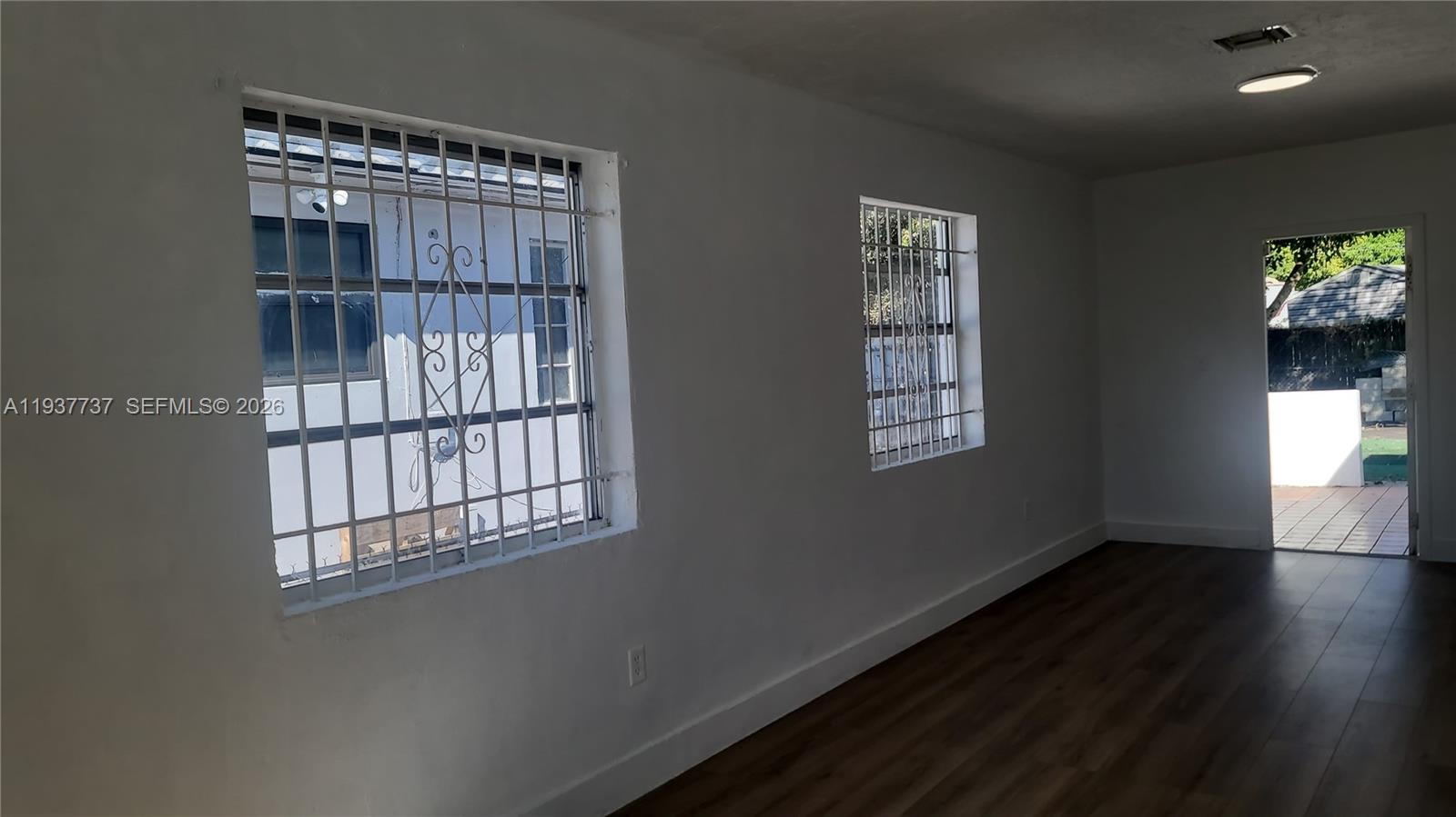 2951 Northwest 49th Street Miami, FL 33142 - Photo 14 of 19 a view of empty room with wooden floor and fan