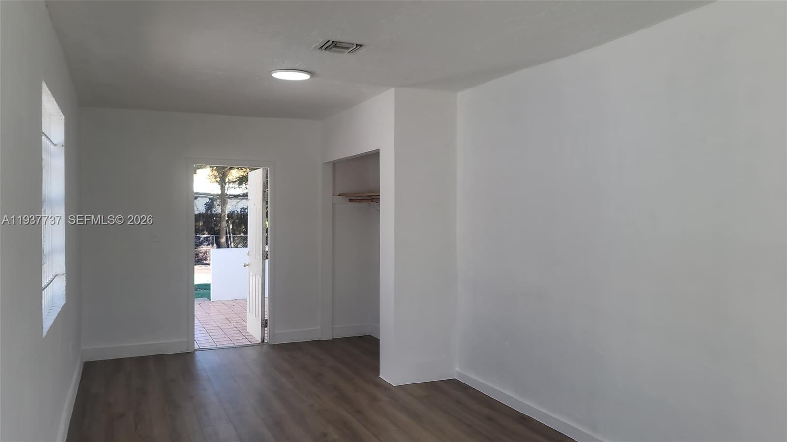 2951 Northwest 49th Street Miami, FL 33142 - Photo 15 of 19 a view of an empty room and wooden floor