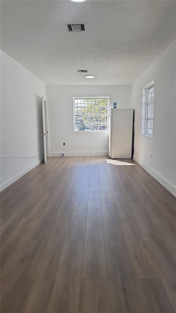2951 Northwest 49th Street Miami, FL 33142 - Photo 16 of 19 wooden floor in an empty room with a window