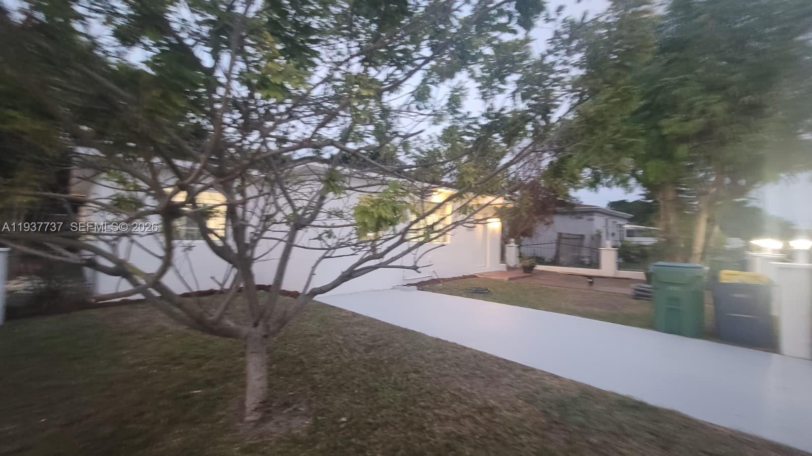 2951 Northwest 49th Street Miami, FL 33142 - Photo 4 of 19 a view of a house with a tree