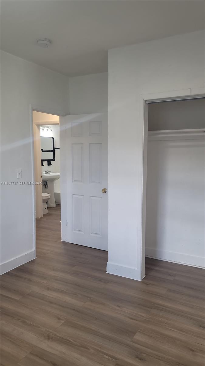 2951 Northwest 49th Street Miami, FL 33142 - Photo 10 of 19 a view of empty room with wooden floor