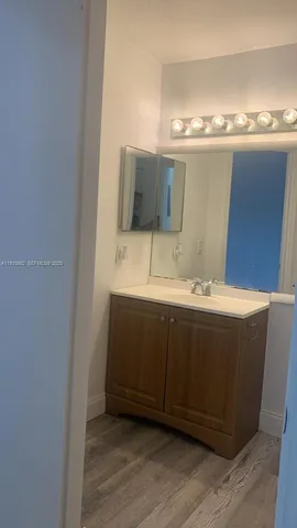a bathroom with a double vanity sink and mirror