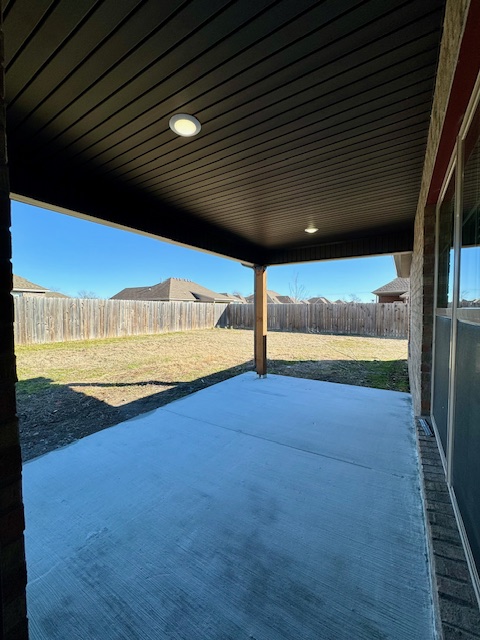 2250 Hunter Drive Pea Ridge, AR 72751 - Photo 20 of 21 Covered concrete patio with recessed lighting, a wood support column, and a fenced backyard
