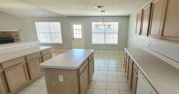 a kitchen with a sink cabinets and window