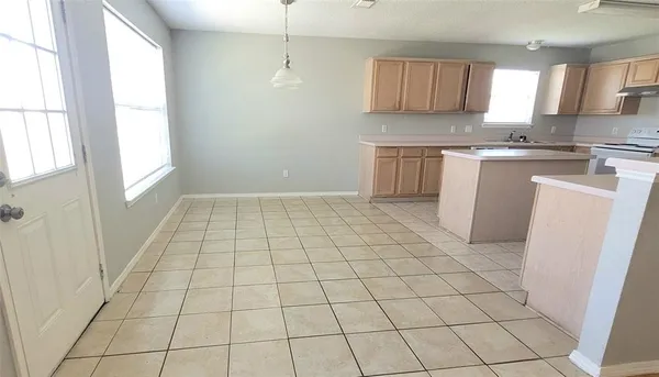 a kitchen with a sink a stove a microwave and cabinets