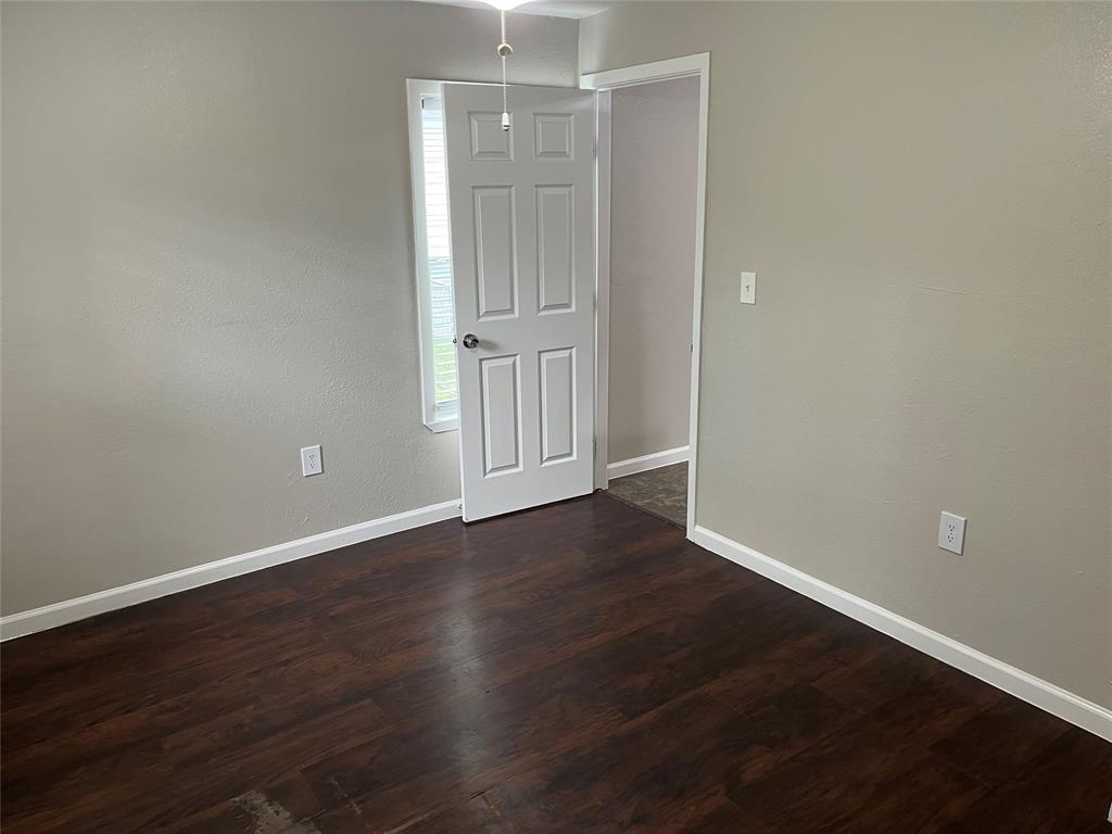 9558 Rylie Crest Drive Dallas, TX 75217 - Photo 7 of 14 Room featuring wood-finish flooring, light neutral wall paint, and white baseboards