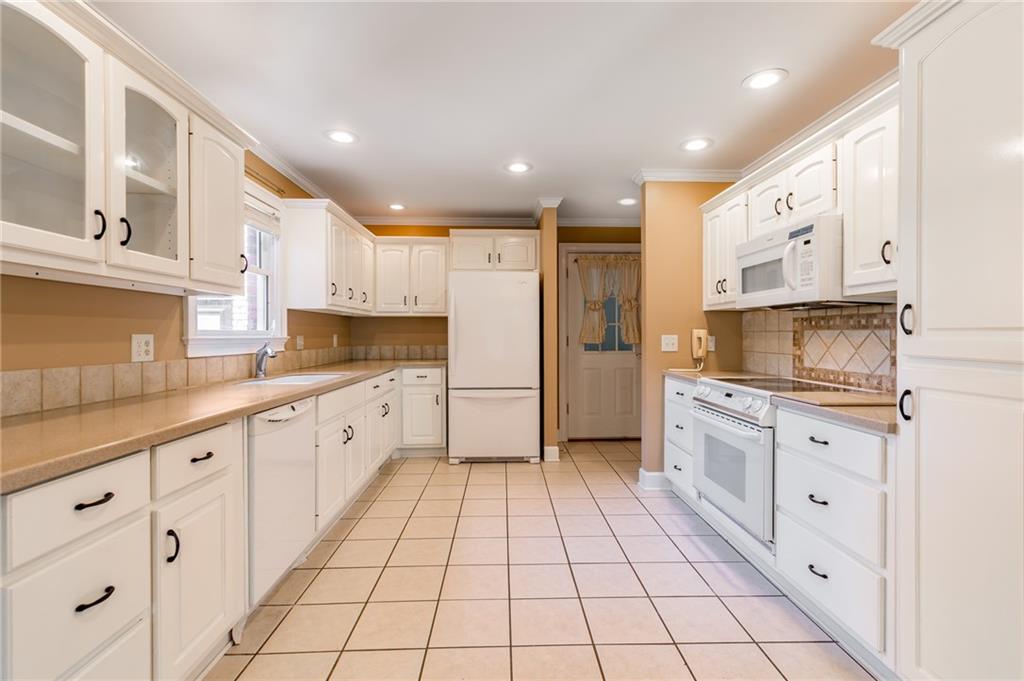 6628 Windvane Point Clermont, GA 30527 - Photo 12 of 41 a large kitchen with stainless steel appliances cabinets a sink and a counter top space