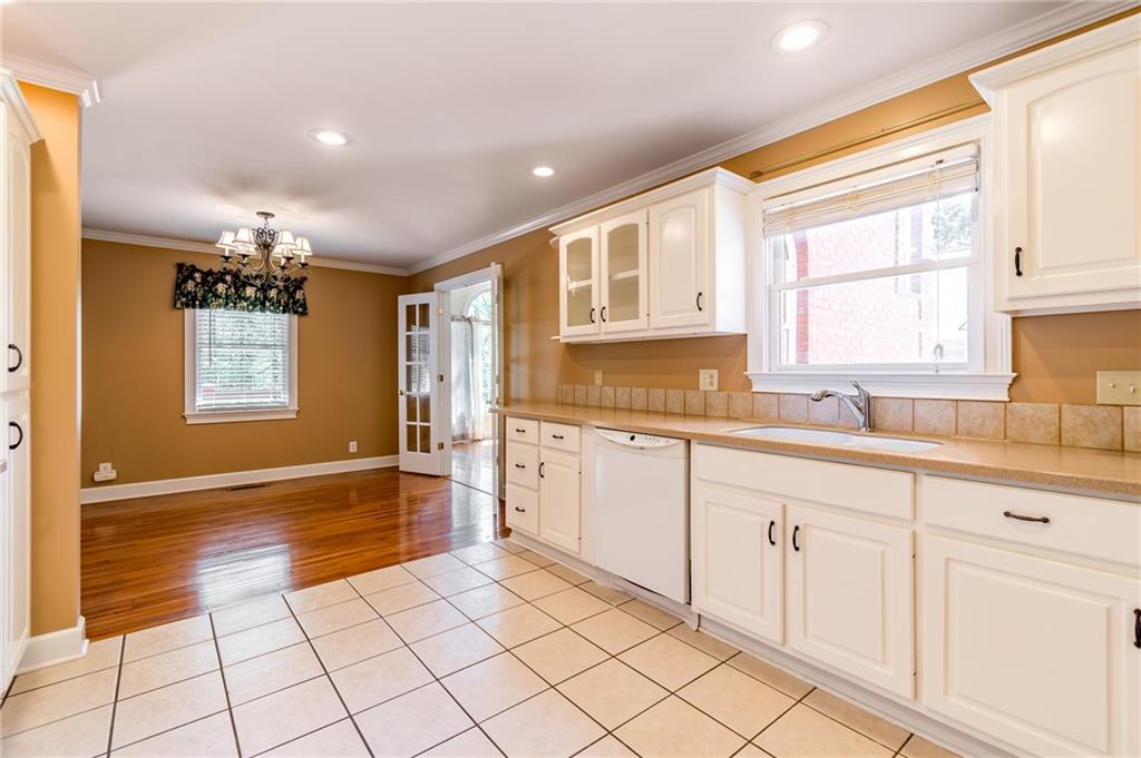 6628 Windvane Point Clermont, GA 30527 - Photo 15 of 41 a kitchen with granite countertop a sink cabinets and window
