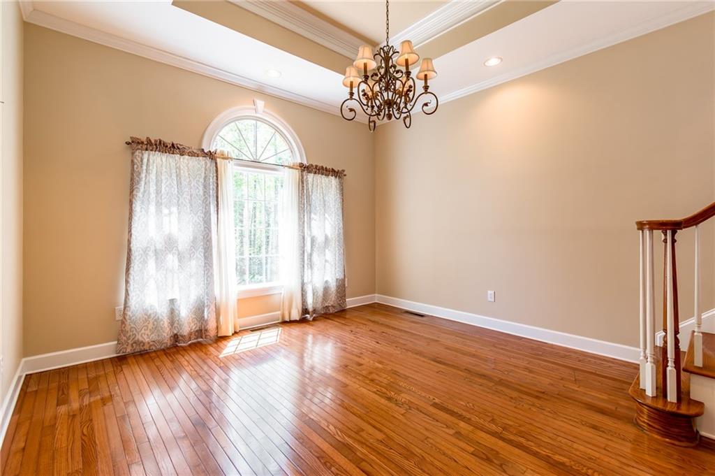 6628 Windvane Point Clermont, GA 30527 - Photo 19 of 41 a view of empty room with wooden floor and fan